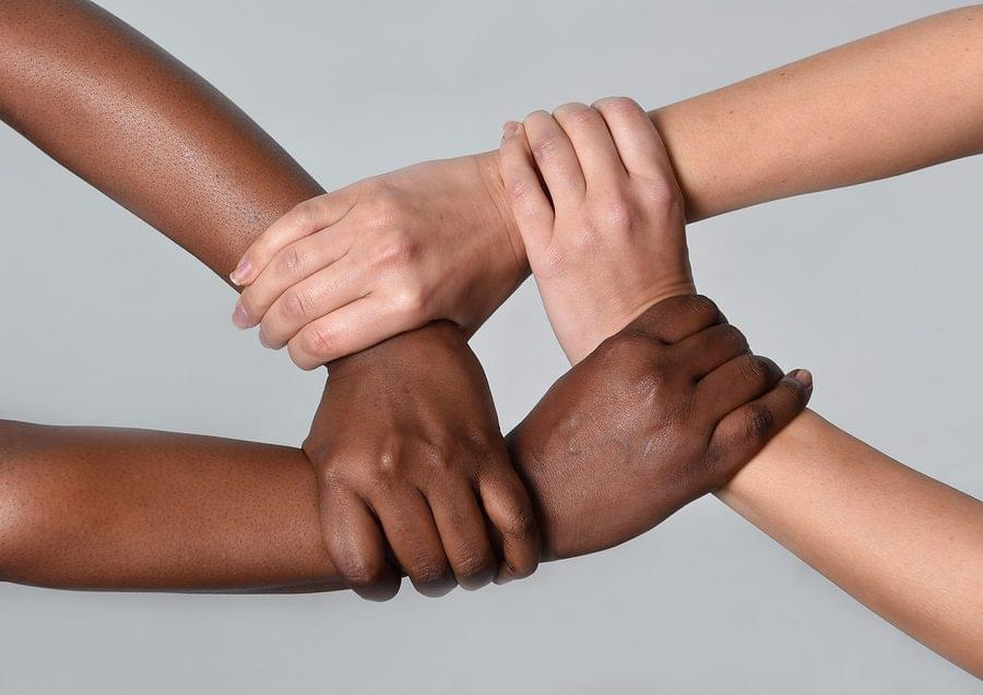 White Caucasian Female And Black African American Hands Holding