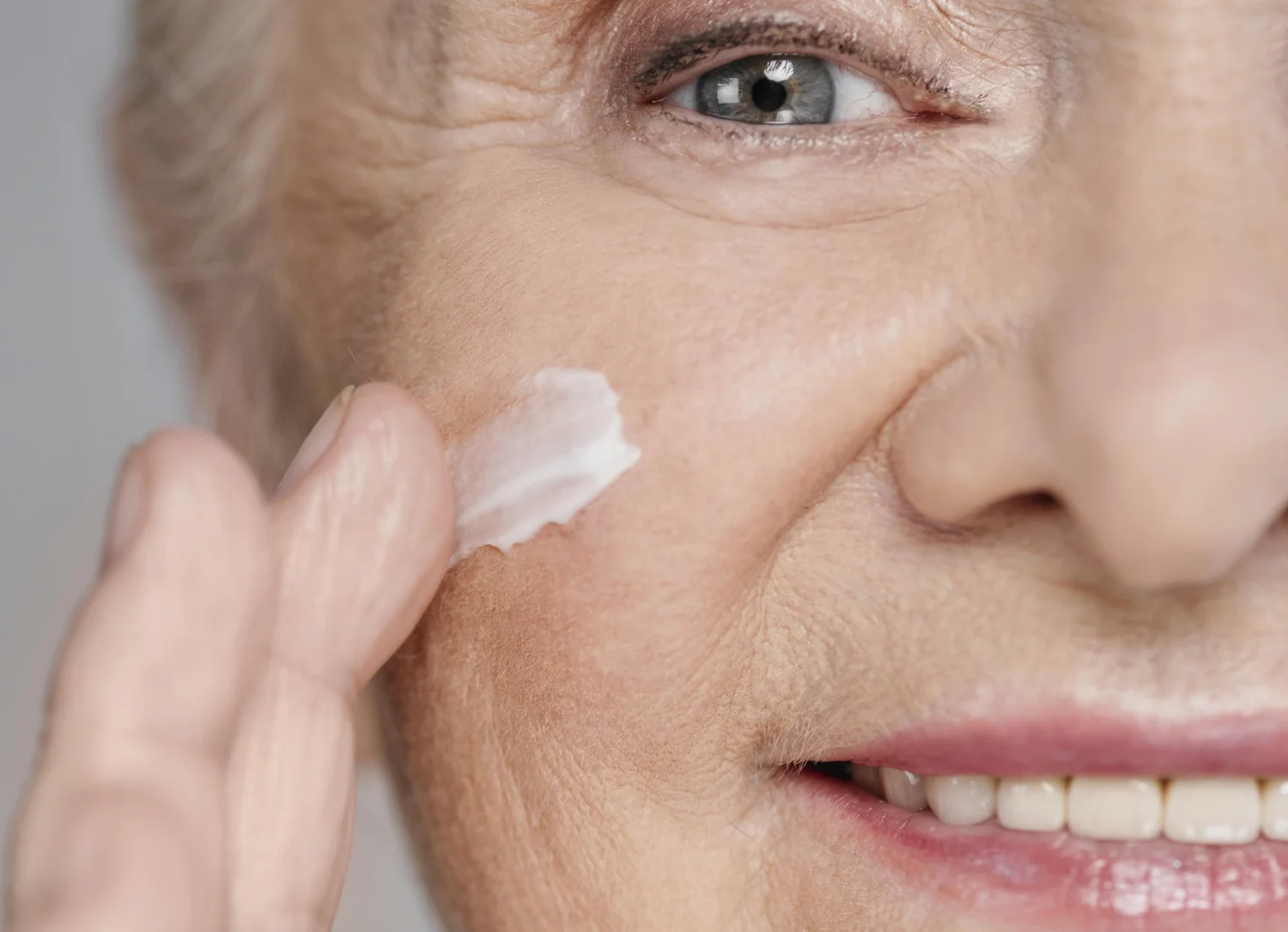 Close up woman using face cream